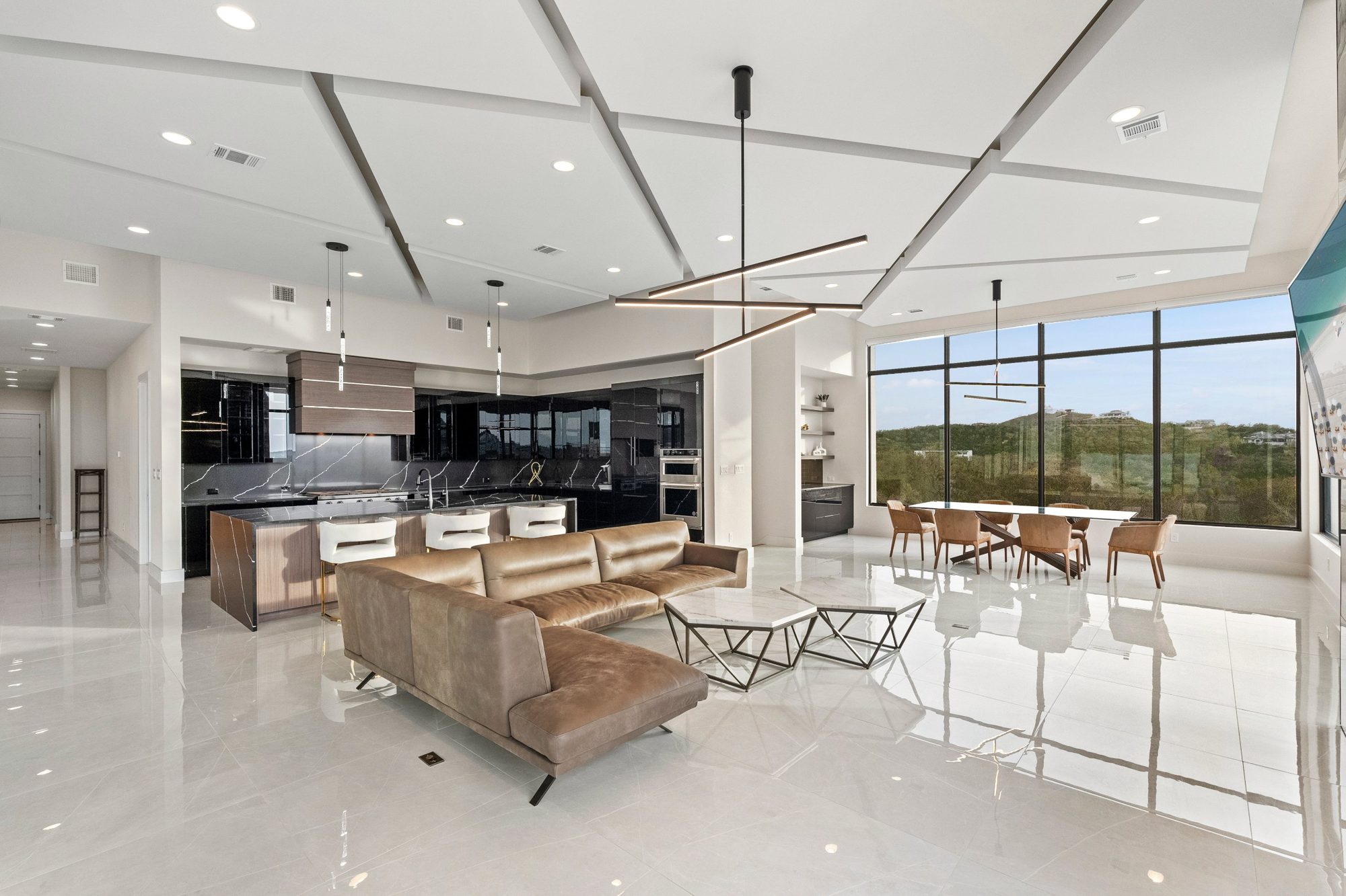 Modern open-plan kitchen and living room with hill-country views