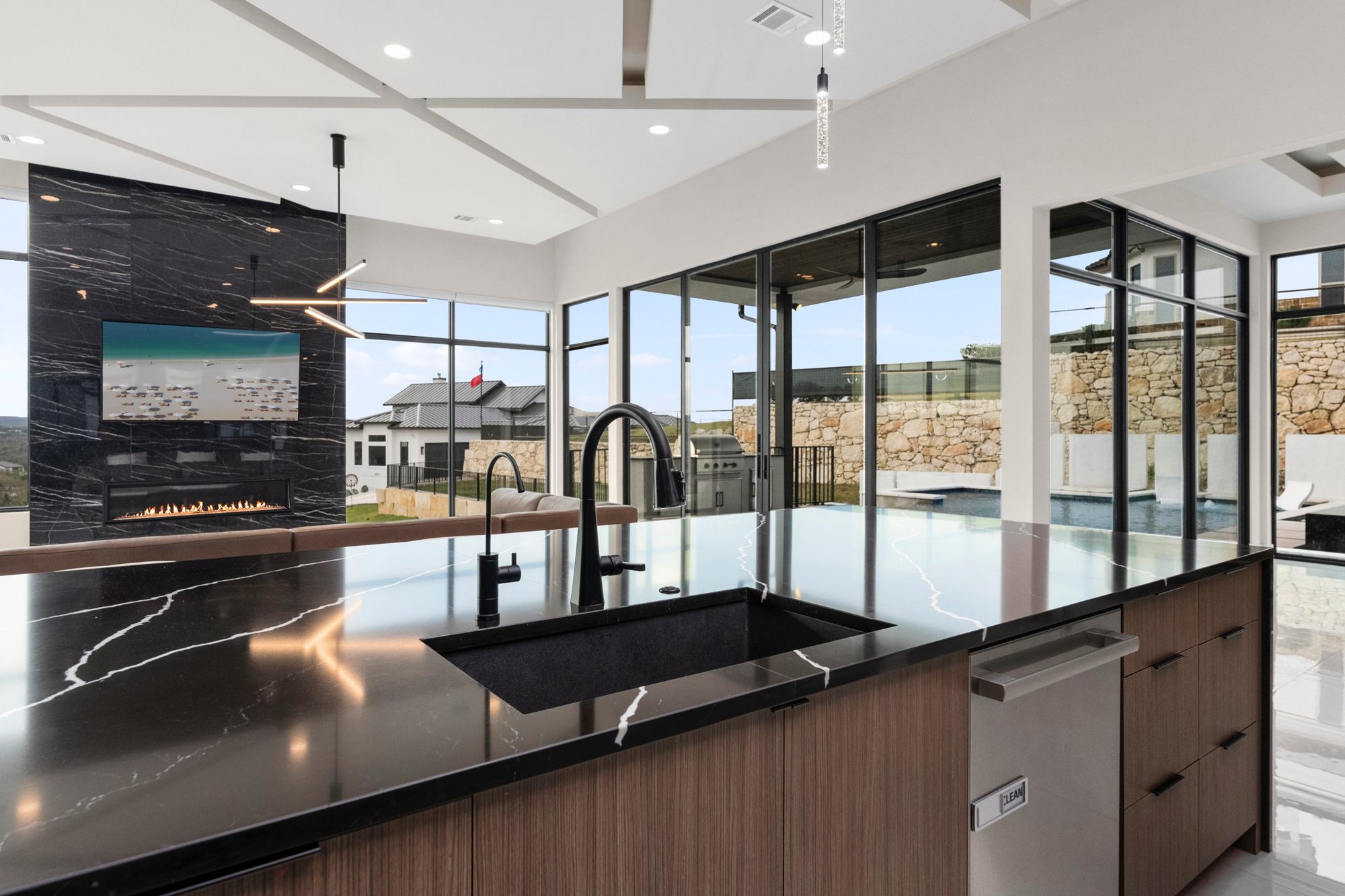 Chef's kitchen with black marble island and fireplace